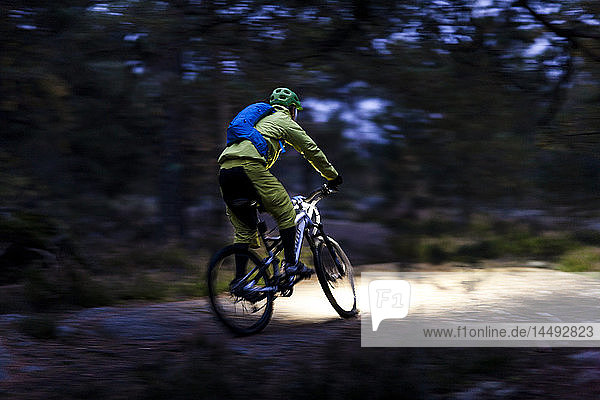 Man cycling through forest Sweden