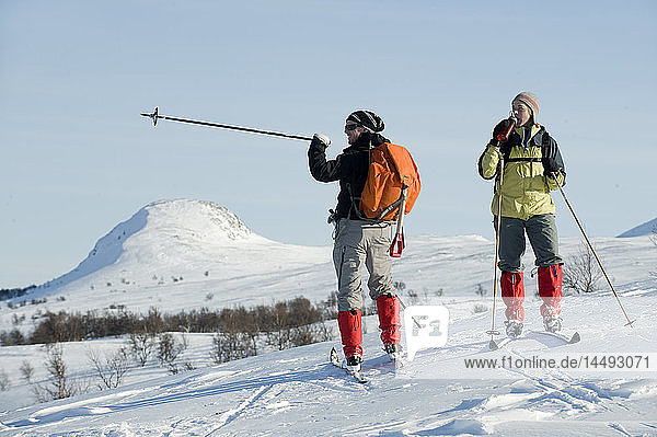 Man and woman skiing in snowcapped area