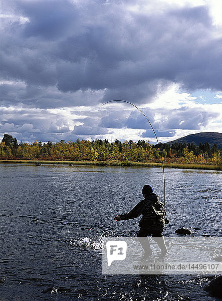 A boy fly-fishing  Lapland  Sweden.