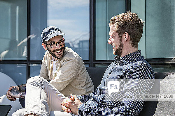 Men talking on balcony