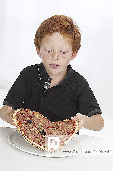 Boy eating pizza.