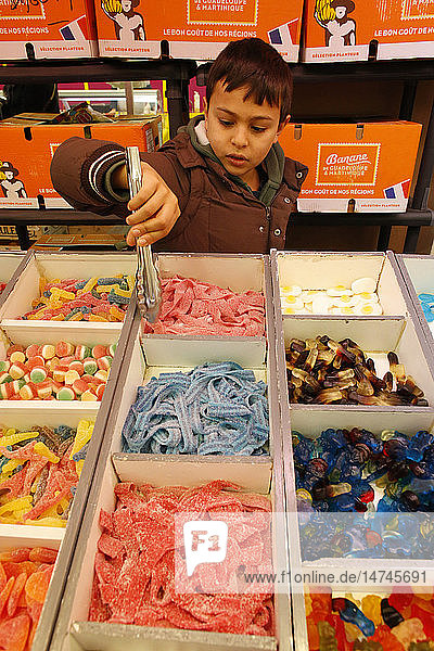 10-year-old boy buying candies.