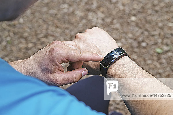 Man checking his connected bracelet.