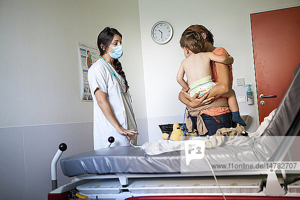 Reportage in the pediatric emergency unit in a hospital in Haute-Savoie  France. A doctor talks to a young boy and his mother.