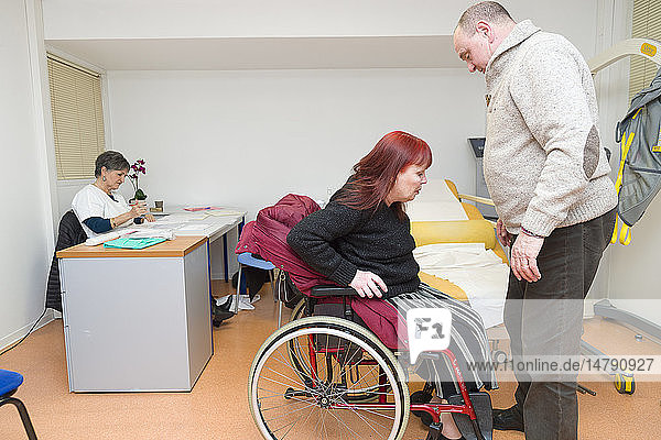 Reportage on the Handi-Consult 06 gynecology practice in the Rossetti Centre Nice France. Handi-Consult 06 provides consultations for disabled adults requiring a substantial amount of setting up and accompanying time. Gynecology consultation with a GP qualified in gynecology and with the help of an auxiliary nurse. This patient who suffers from multiple sclerosis has come with her husband.