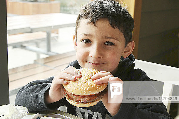 CHILD EATING A SANDWICH