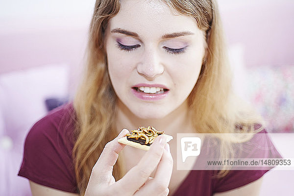 Frau isst Mehlwürmer.