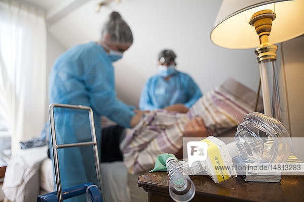 Reportage über einen häuslichen Pflegedienst in Savoie  Frankreich. Eine Krankenschwester und eine Hilfskraft legen einen VAC-Therapie-Verband auf eine Pulmonektomie. Während der Behandlung kann der Patient Distickstoffoxidgas verwenden.