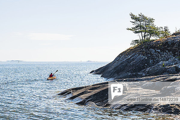 Man kayaking on sea