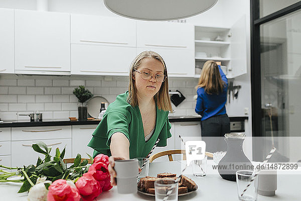 Teenage girl preparing table