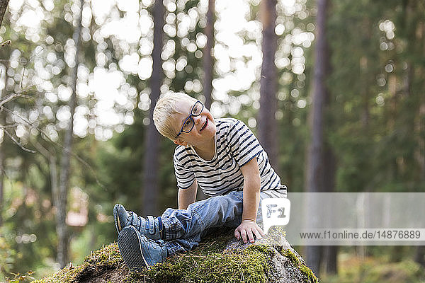 Boy posing in forest