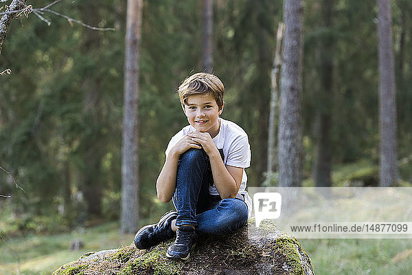Boy posing in forest