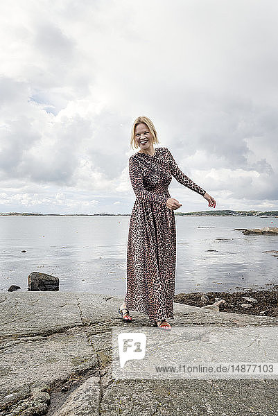 Blonde woman by sea