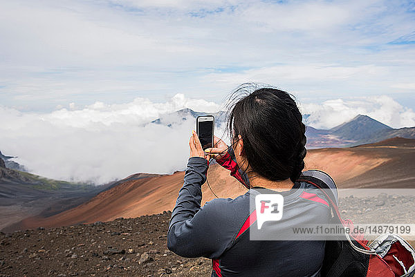 Hiker taking photograph  Haleakala National Park  Maui  Hawaii