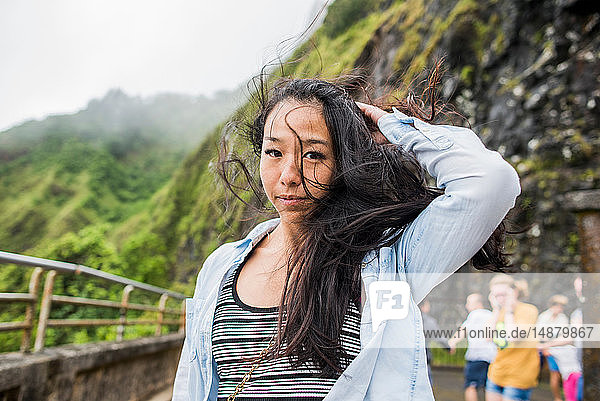 Woman with windswept hair  Nu‘uanu Pali Lookout  Oahu  Hawaii