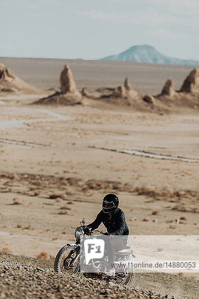 Motorcyclist riding in desert  Trona Pinnacles  California  US