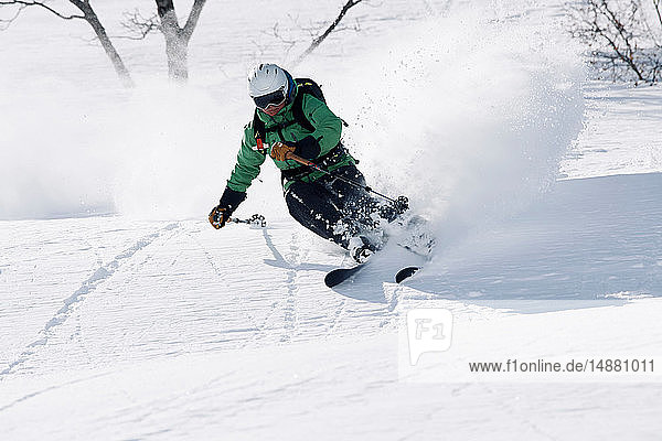 Male skier swerve skiing down mountain  Alpe-d'Huez  Rhone-Alpes  France