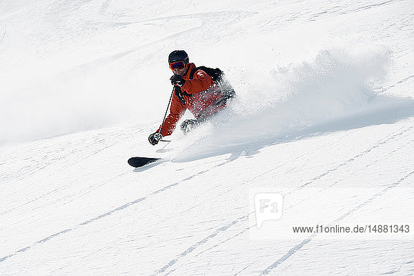 Male skier skiing down mountain  Alpe-d'Huez  Rhone-Alpes  France