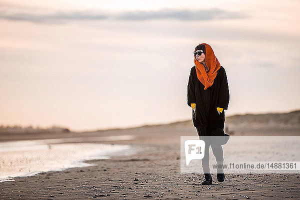 Woman walking alone on beach