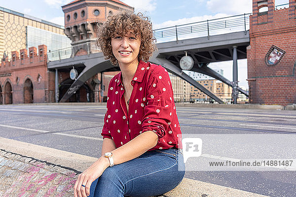 Young woman resting on Oberbaum bridge in city  Berlin  Germany