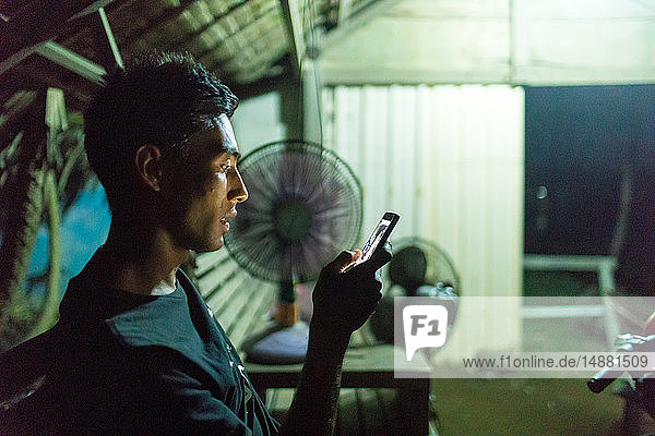 Man texting by fans  Abulug  Cagayan  Philippines