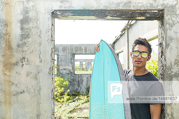 Surfer by doorway of abandoned building  Abulug  Cagayan  Philippines