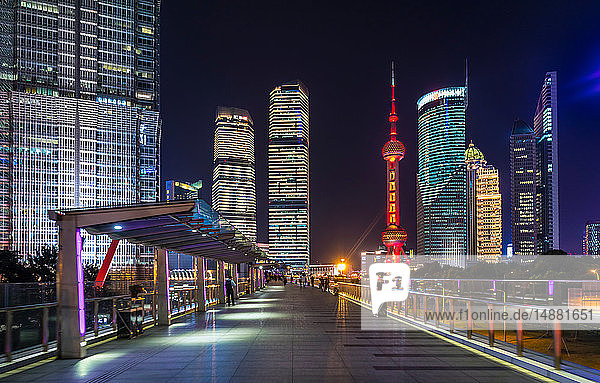 Pudong skyline with Oriental Pearl Tower from elevated walkway at night  Shanghai  China