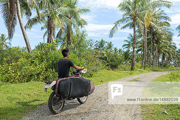 Motorcyclist with surfboard  Abulug  Cagayan  Philippines