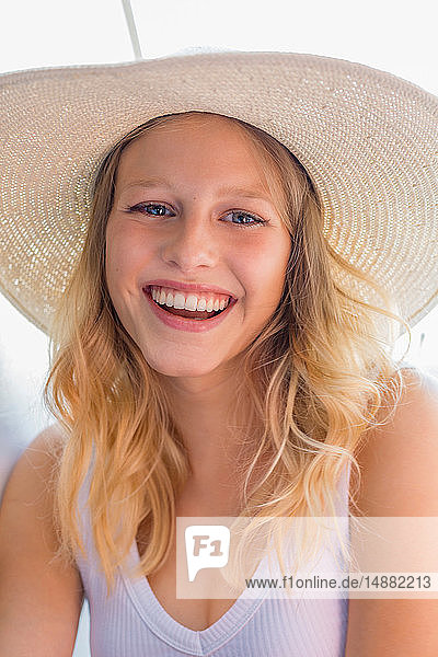 Young blond haired woman in straw hat  portrait