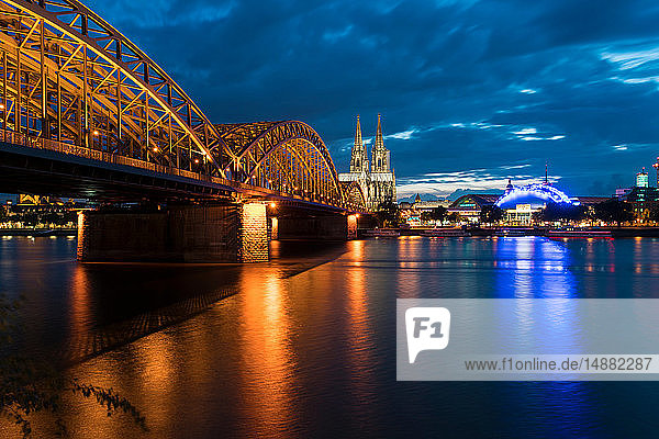 Dome Cathedral  Hohenzollern bridge and theater along Rhine river at night  Cologne  Nordrhein-Westfalen  Germany