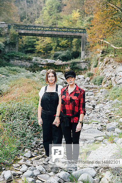 Women standing in dry riverbed  Rezzago  Lombardy  Italy