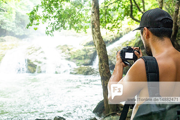 Trekker photographing Tanap-Avis Falls  Bagui  Ilocos Norte  Philippines