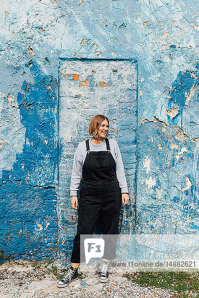 Portrait of woman  weathered wall in background