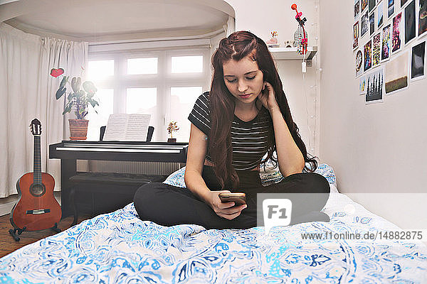Teenager social networking on bed