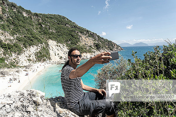 Man taking selfie on cliff top  Lefkada Island  Levkas  Greece