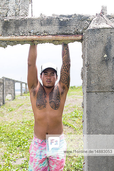 Man on abandoned site by sea  Pagudpud  Ilocos Norte  Philippines