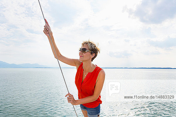 Mature woman sailing on Chiemsee lake  Bavaria  Germany