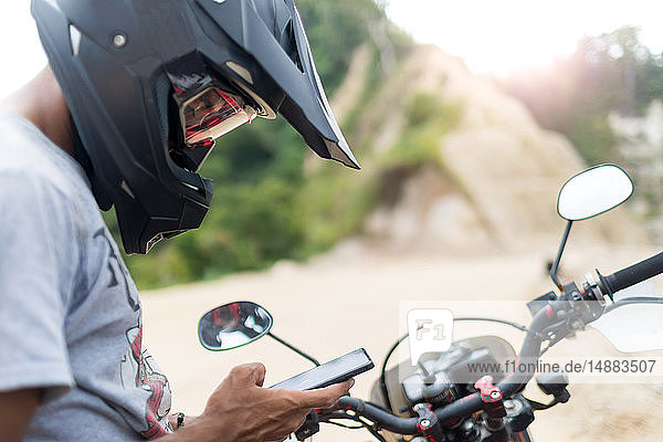 Motorcyclist stopping to text  Pagudpud  Ilocos Norte  Philippines