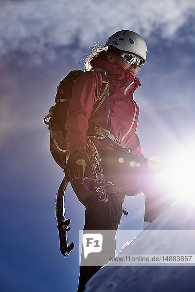 Mountain climber ascending mountain in bright sunlight  Chamonix  Rhone-Alps  France
