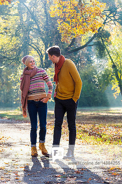 Couple walking in autumnal park  Strandbad  Mannheim  Germany