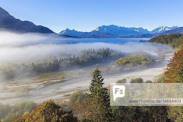 Germany  Upper Bavaria  Aerial view of Upper Isar Valley with fog  Wetterstein mountains in the background