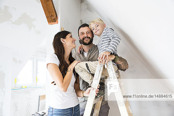 Portrait of happy family working on loft conversion