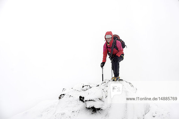 UK  Scotland  Glen Spean  woman climbing East ridge of Beinn a Caorainn in winter