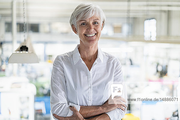 Portrait of smiling senior businesswoman in a factory