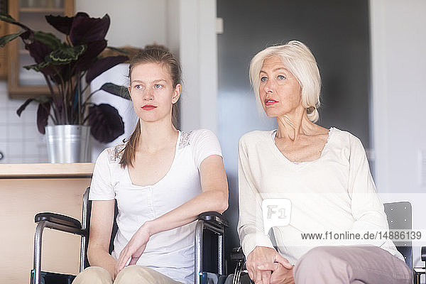 Mother with daughter in a wheelchair  looking