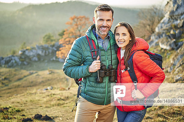 Portrait of happy couple on a hiking trip in the mountains