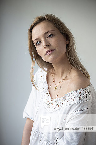 Portrait of young woman  wearing white dress