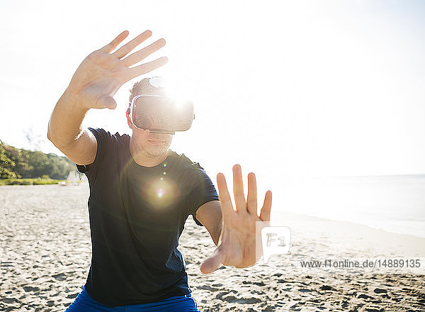 Man wearing VR glasses on the beach