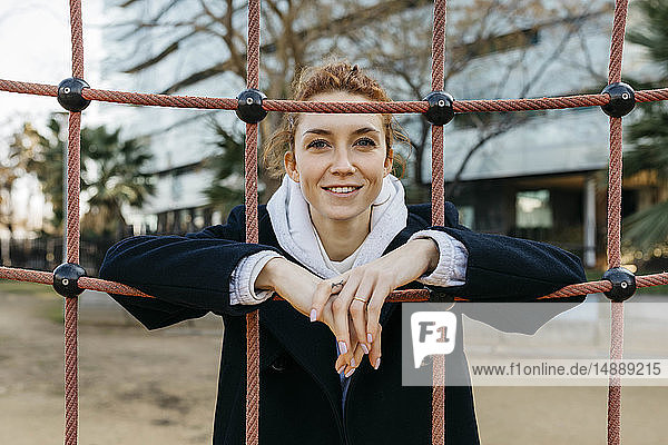 Portrait of smiling young woman on a playground