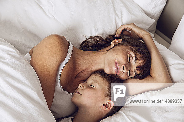 Mutter und Sohn kuscheln im Bett